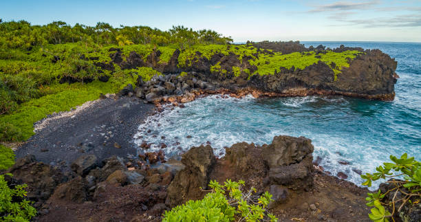 istock Marvelous shore. Large boulder among the waves in the sea. Hawaii 1268237850