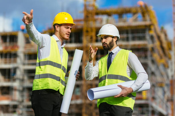 istock Two coworkers talking about business plan 1268238652