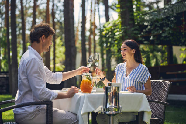 istock Happy couple in restaurant looking each other and toasting 1268239021