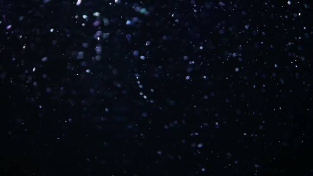 istock Abstract fast crystal macro Bubbles of air moving and floating isolated on Black Background in aquarim under water. Close up and copy space. Like a winter 1268240385