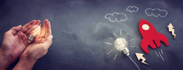 istock education or innovation concept. Wooden rocket over blackboard background. top view 1268240854