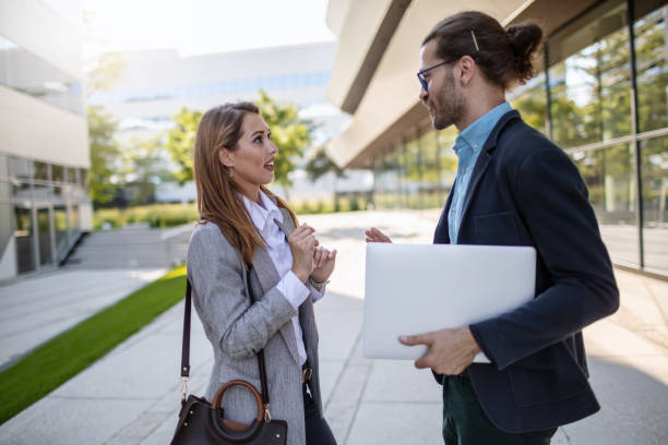 istock Business colleagues discussing project on their way to office 1268241739