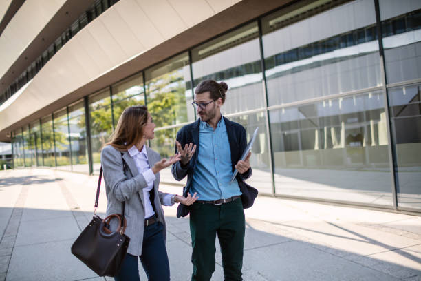 istock Business colleagues discussing project on their way to office 1268241796