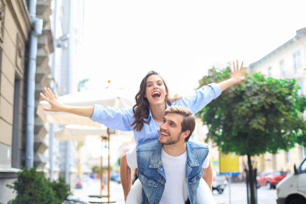 istock Handsome young man carrying young attractive woman on shoulders while spending time together outdoors. 1268241956