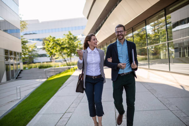 istock Cheerful business persons walking together 1268242179