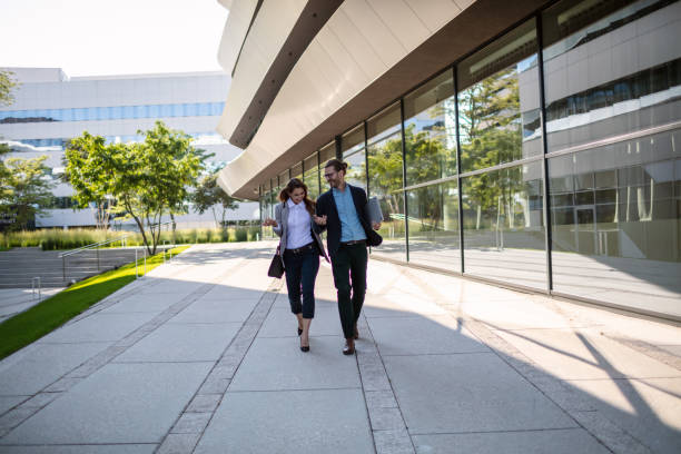 istock Cheerful business persons walking together 1268242293
