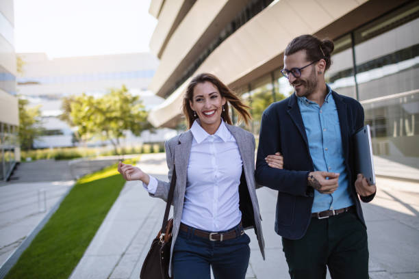 istock Cheerful business persons walking together 1268242852