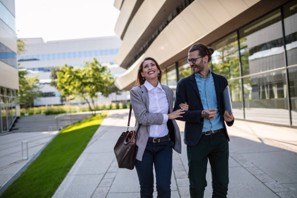 istock Cheerful business persons walking together 1268242980