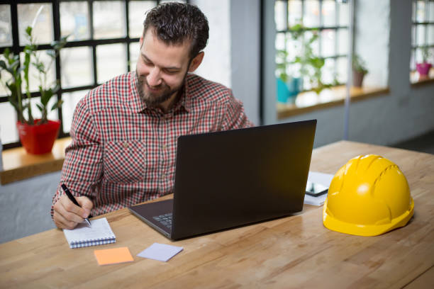 istock Young businessman writing down plans for the new project 1268243163