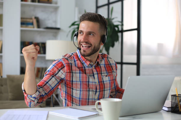 istock Handsome businessman is keeping arms raised and expressing joyful at home office. 1268244462