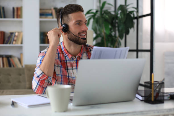 istock Concentrated young freelancer businessman using laptop for video conferance, working remotely online at home. 1268244869