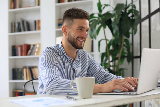 istock Happy young business man is analizing financial documents from home during self isolation. 1268245811