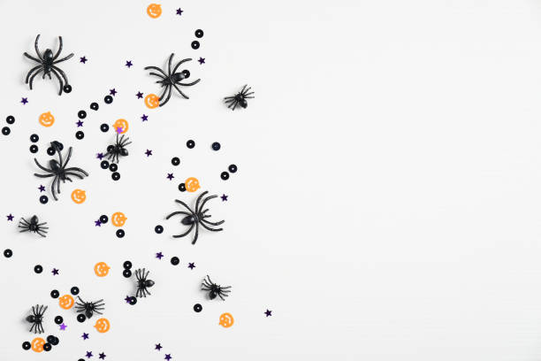istock White halloween background with spiders and confetti. Top view with copy space, flat lay. Happy Halloween holiday concept. Halloween sale banner mockup 1268245864