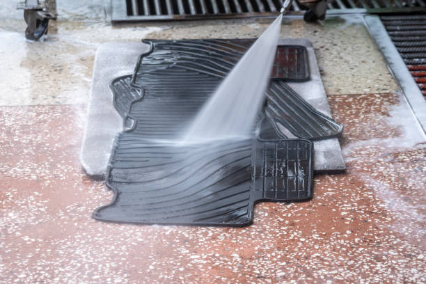 istock A man washes a black car mat with a strong stream of water 1268245928