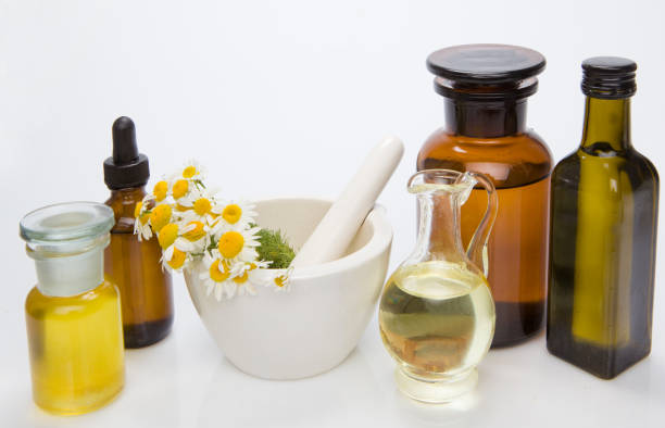 istock Homeopathic medicine concept of mortar and fresh herbs. 1268248877