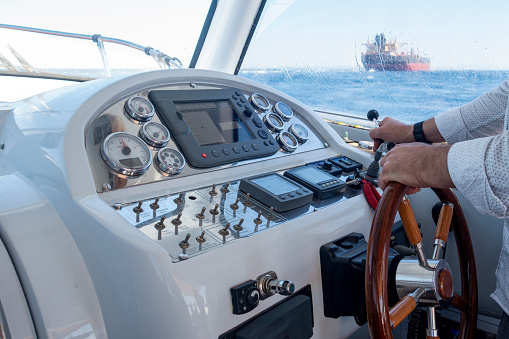 Portrait of cute boy happy excited smiling caucasian boy enjoy sailing on motor boat