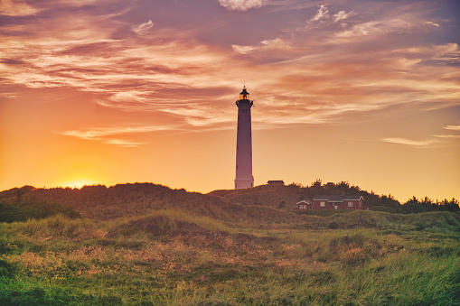 Beautiful sunset behind the white lighthouse Lyngvid in Denmark.