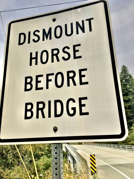 istock dismount horse before bridge - sign 1268253441