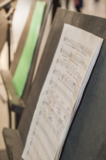 istock Musical notes on a music stand on a blurred background, vertical, DOF, side view 1268253572