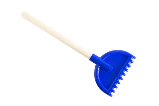 Blue kids toy rake on white background, isolate, preschool