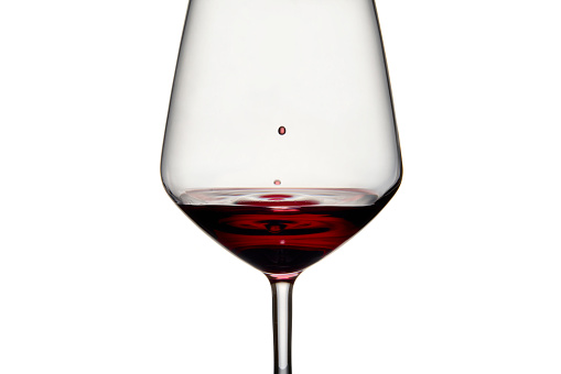 a glass of wine with a elegant black backdrop. Cropped for copy space.