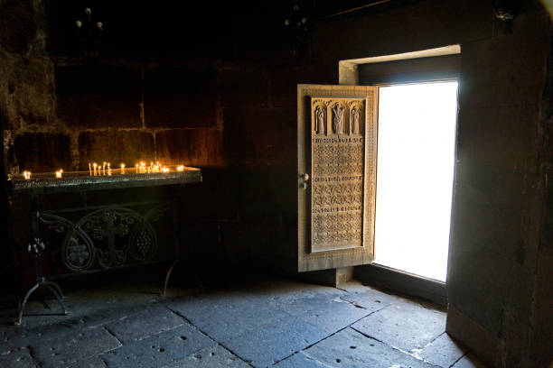 Hripsime Church, Armenia: Ornately carved wooden door with sacrificial candles. The church is one of the oldest surviving churches in the country (seventh century) with remains of the martyr Hripsime
