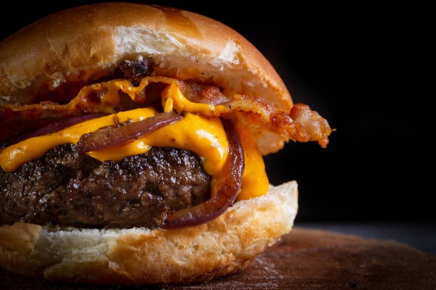 istock Craft beef burger with cheddar cheese, bacon, caramelized onion and garlic mustard sauce. 1268258089