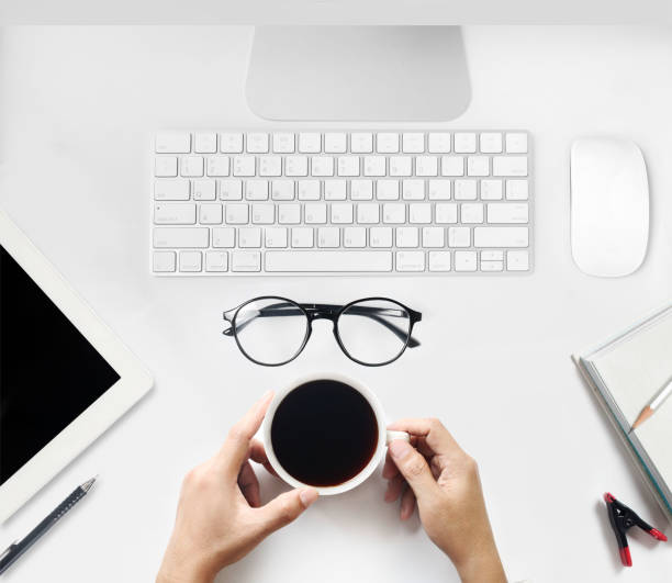 istock A top view of a man holding a coffee cup on a modern workplace 1268260797