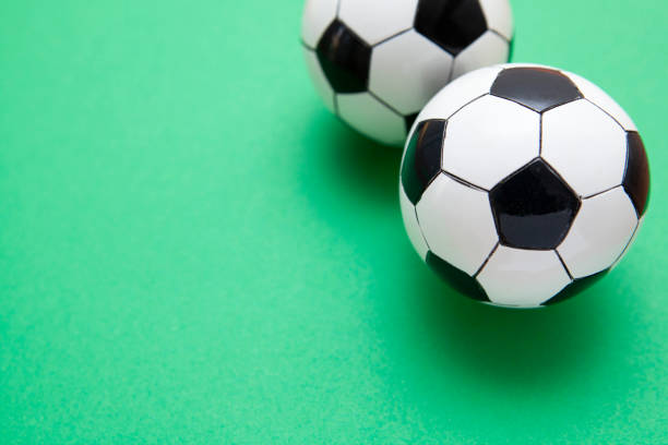 istock Mini soccer balls on a green surface with copy space 1268260839