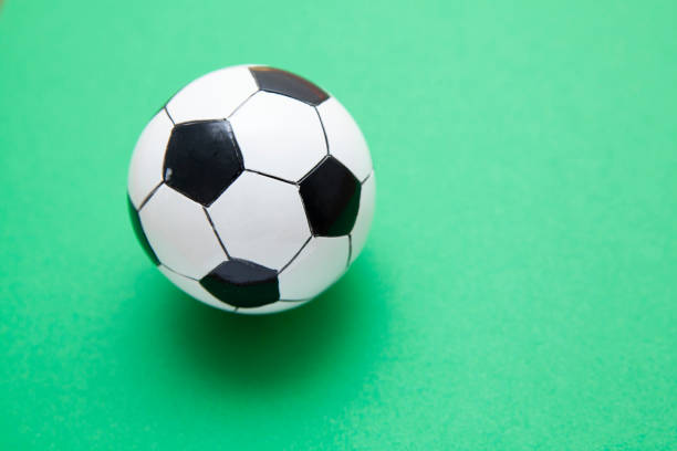 istock Mini soccer balls on a green surface with copy space 1268260919