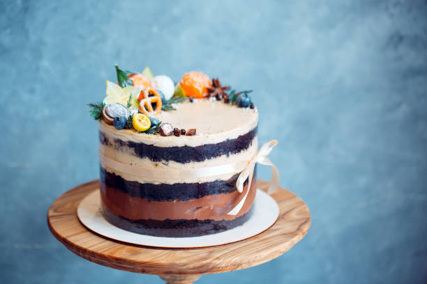 istock Naked cake decorated with fruit on the blue baskground. 1268260953