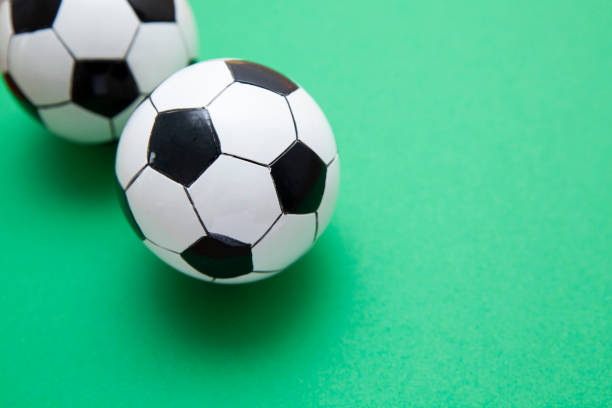istock Mini soccer balls on a green surface with copy space 1268261026