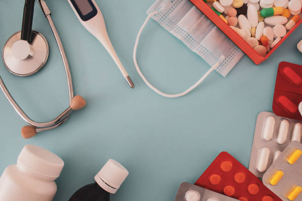 istock pills and medical tools on blue background 1268261699