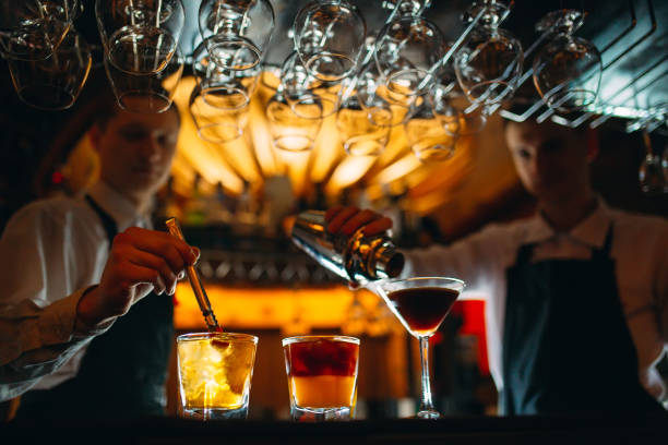 the bartender prepares cocktails at the bar. - men elegance cocktail cool imagens e fotografias de stock