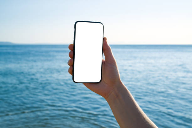 istock Woman holding and touching blank screen template smart phone. Smart phone screen is empty. 1268262578