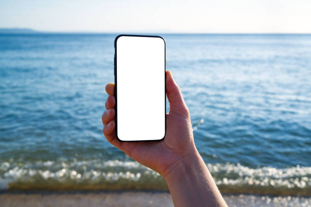 istock Woman holding and touching blank screen template smart phone. Smart phone screen is empty. 1268262959