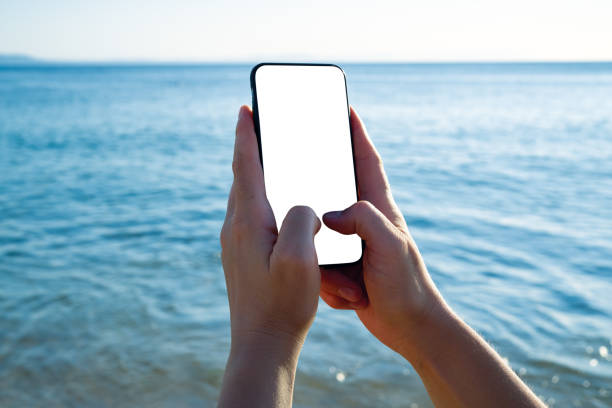 istock Woman holding and touching blank screen template smart phone. Smart phone screen is empty. 1268263095