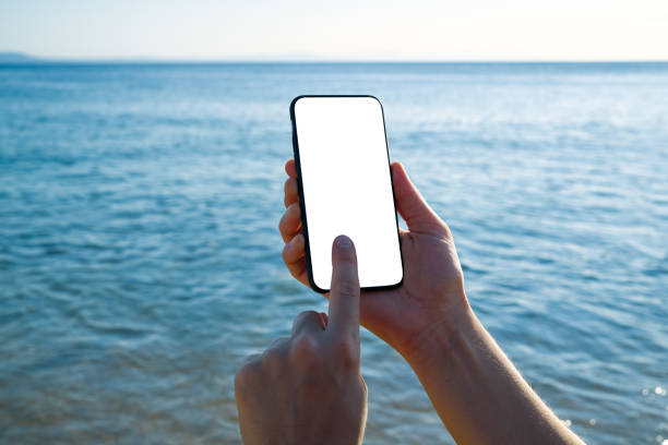 istock Woman holding and touching blank screen template smart phone. Smart phone screen is empty. 1268263106