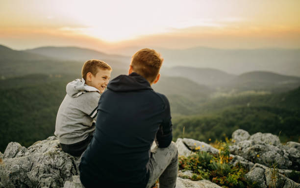 istock Two brother resting after hiking 1268263324