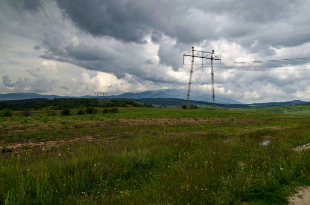 istock Springtime forest with glade and General electric power transmission line, Plana mountain 1268263917