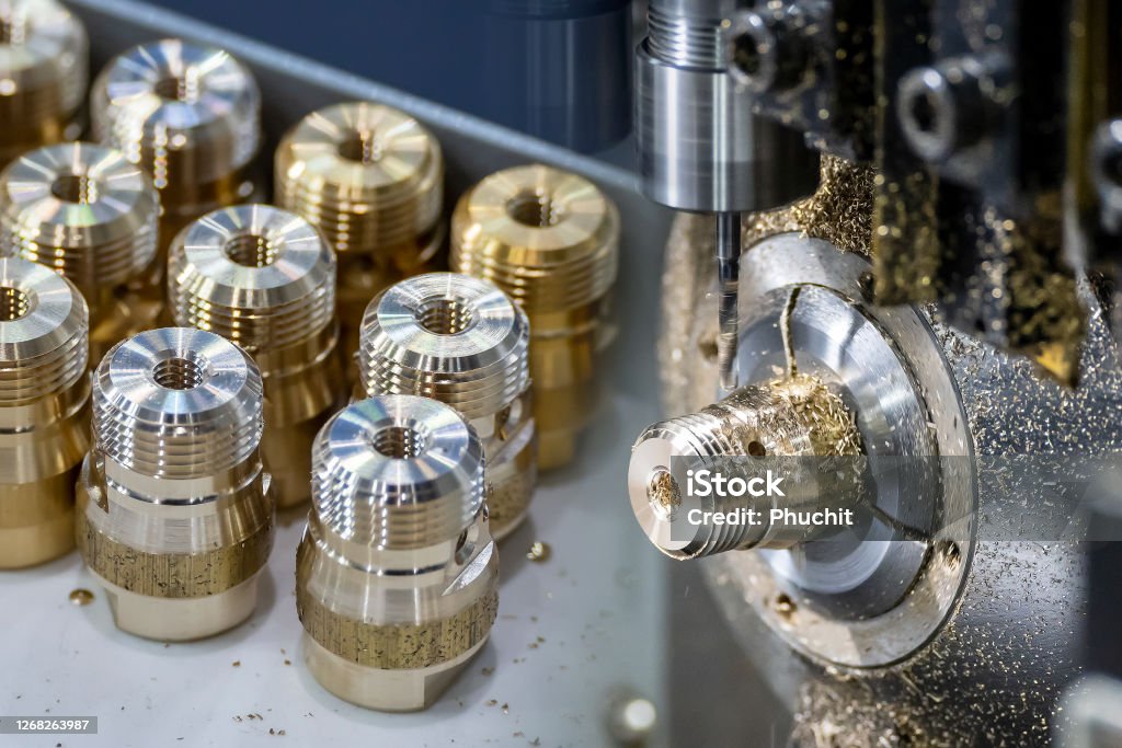 The  abstract scene multi-tasking CNC lathe machine swiss type and pipe connector parts. The  abstract scene multi-tasking CNC lathe machine swiss type and pipe connector parts. The hi-technology brass fitting connector manufacturing by machining center. CNC Machine Stock Photo