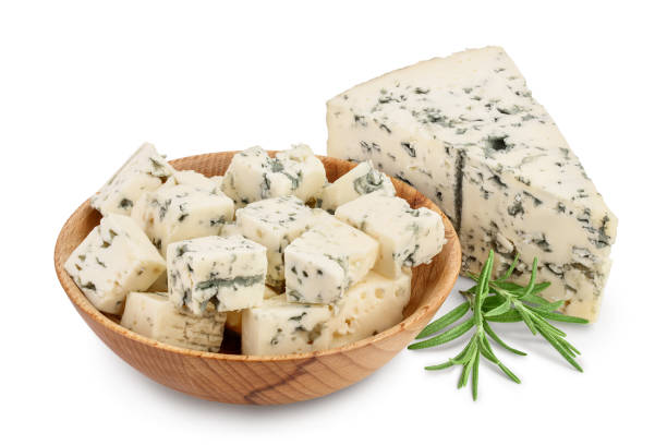 diced Blue cheese in wooden bowl isolated on white background with clipping path and full depth of field. diced Blue cheese in wooden bowl isolated on white background with clipping path and full depth of field blue cheese stock pictures, royalty-free photos & images