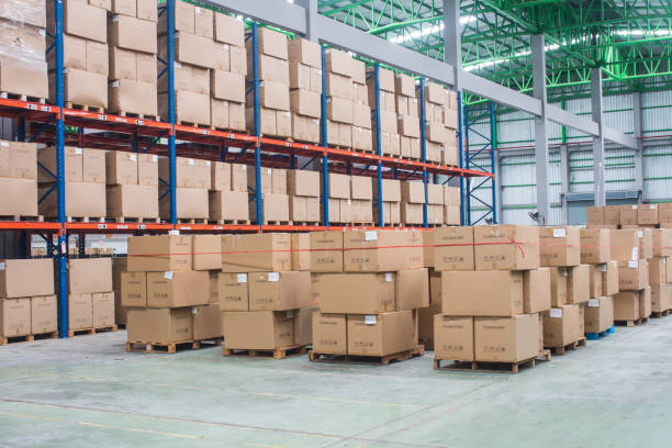 istock interior of warehouse. Rows of shelves with boxes 1268266157