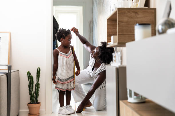 istock Mother checking daughters height at home 1268266712