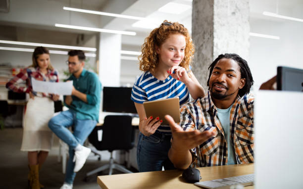 istock Creative brainstorming. Happy business people, designers, architects working as a team in office 1268268414