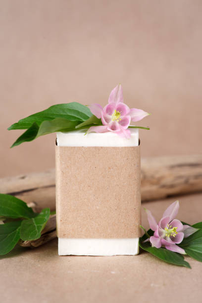 istock Zero waste natural cosmetics products on craft paper table. Flat lay, organic solid soap and shampoo bars, antibacterial handcrafted soap concept, mock up, organic detail, tropical flowers 1268269126