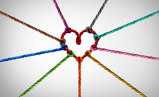Diversity partnership and concept of team unity and teamwork idea as a business metaphor for joining diverse ropes connected together as a heart for cooperation and working collaboration.
