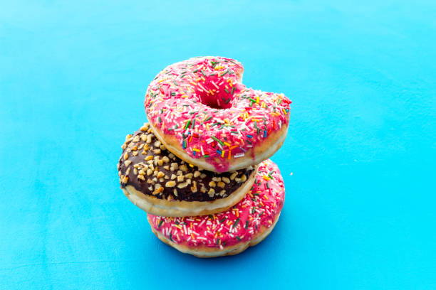 istock Colorful donuts close up, glazed and sprinkles bakery 1268270361