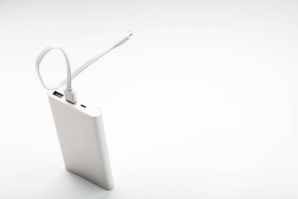 istock Power Bank for charging your smartphone on a white background. Universal external battery for gadgets free space and minimalistic composition. 1268270369
