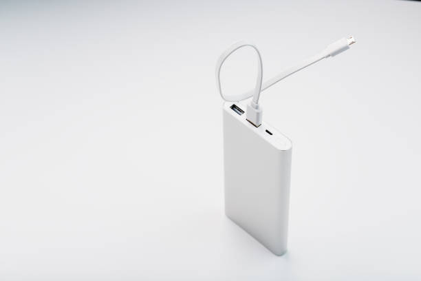 istock Power Bank for charging your smartphone on a white background. Universal external battery for gadgets free space and minimalistic composition. 1268270379